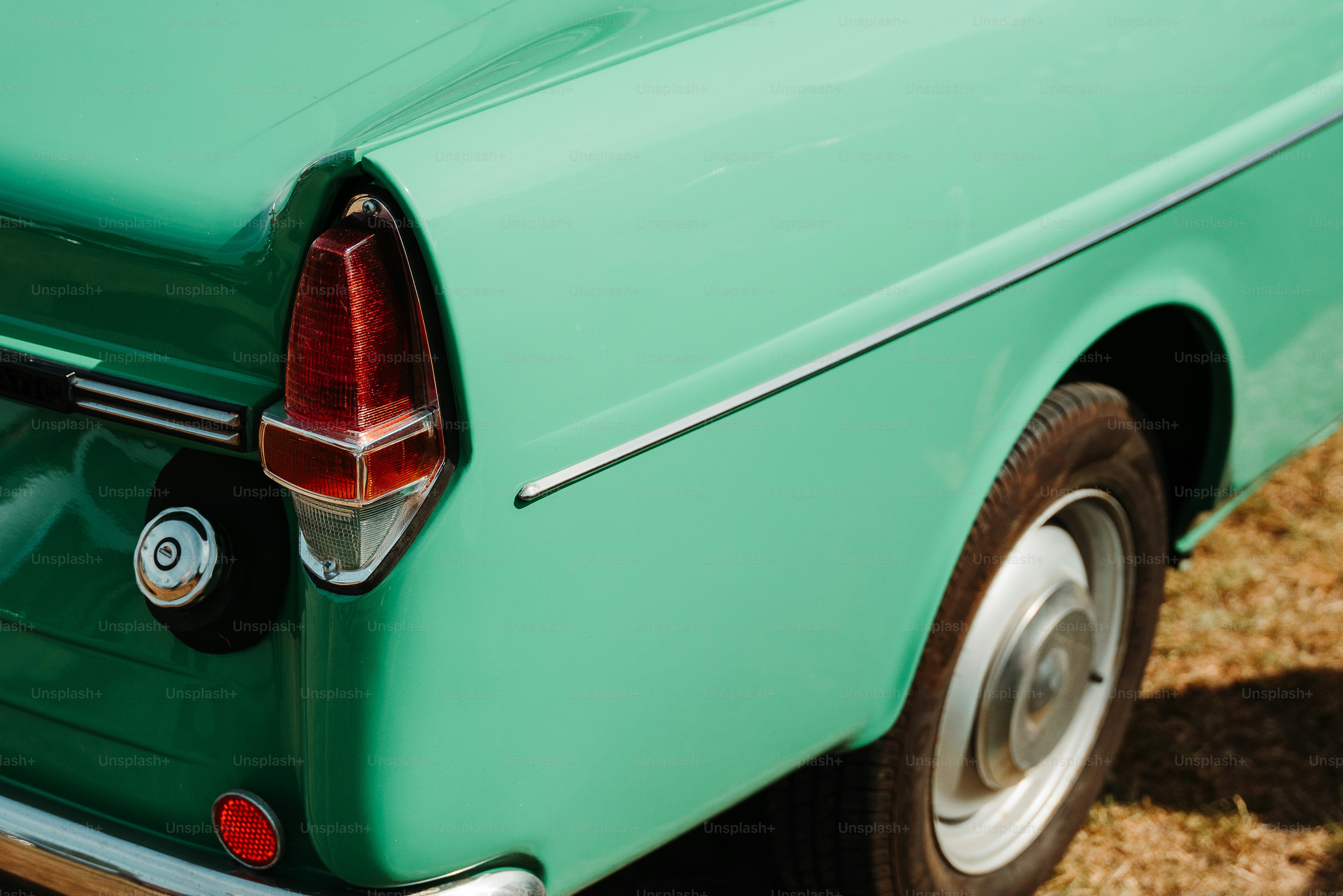 photo of a car's tail light and tire