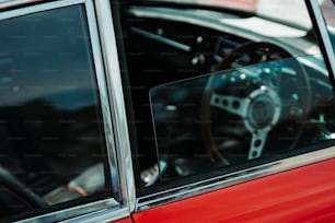 a red car with a steering wheel and dashboard