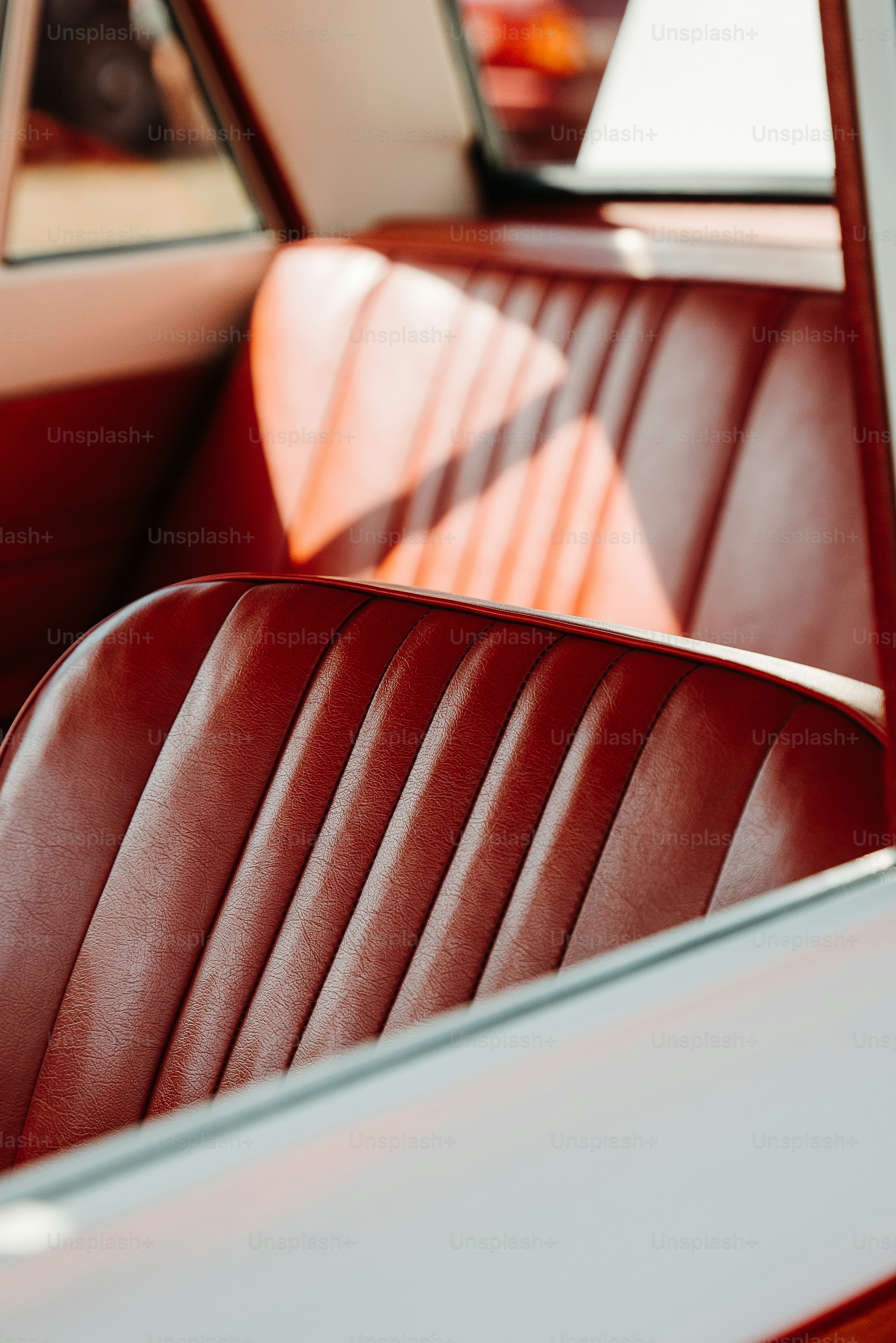 the interior of a car with a red leather seat