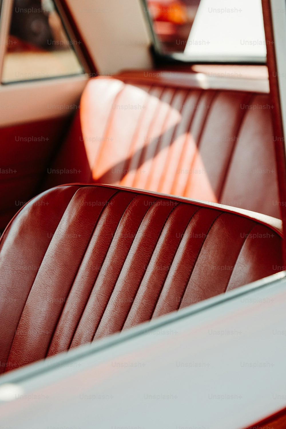 the interior of a car with a red leather seat