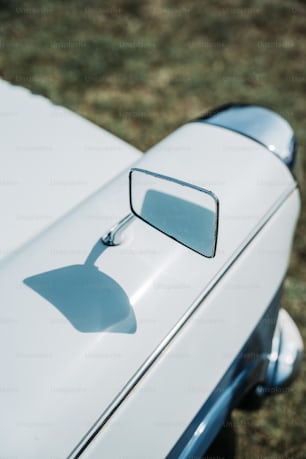 a close up of the side mirror of a white car