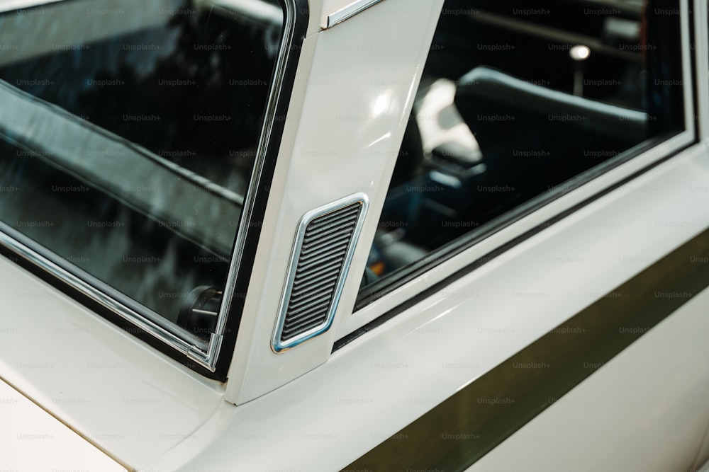 a close up of a white car with a window