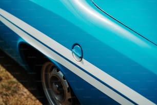 a close up of a blue car with white stripes