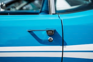 a close up of a blue and white car door handle