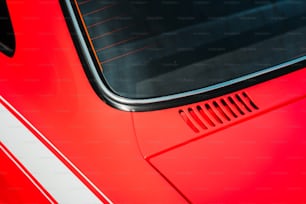a close up of a red sports car's side window