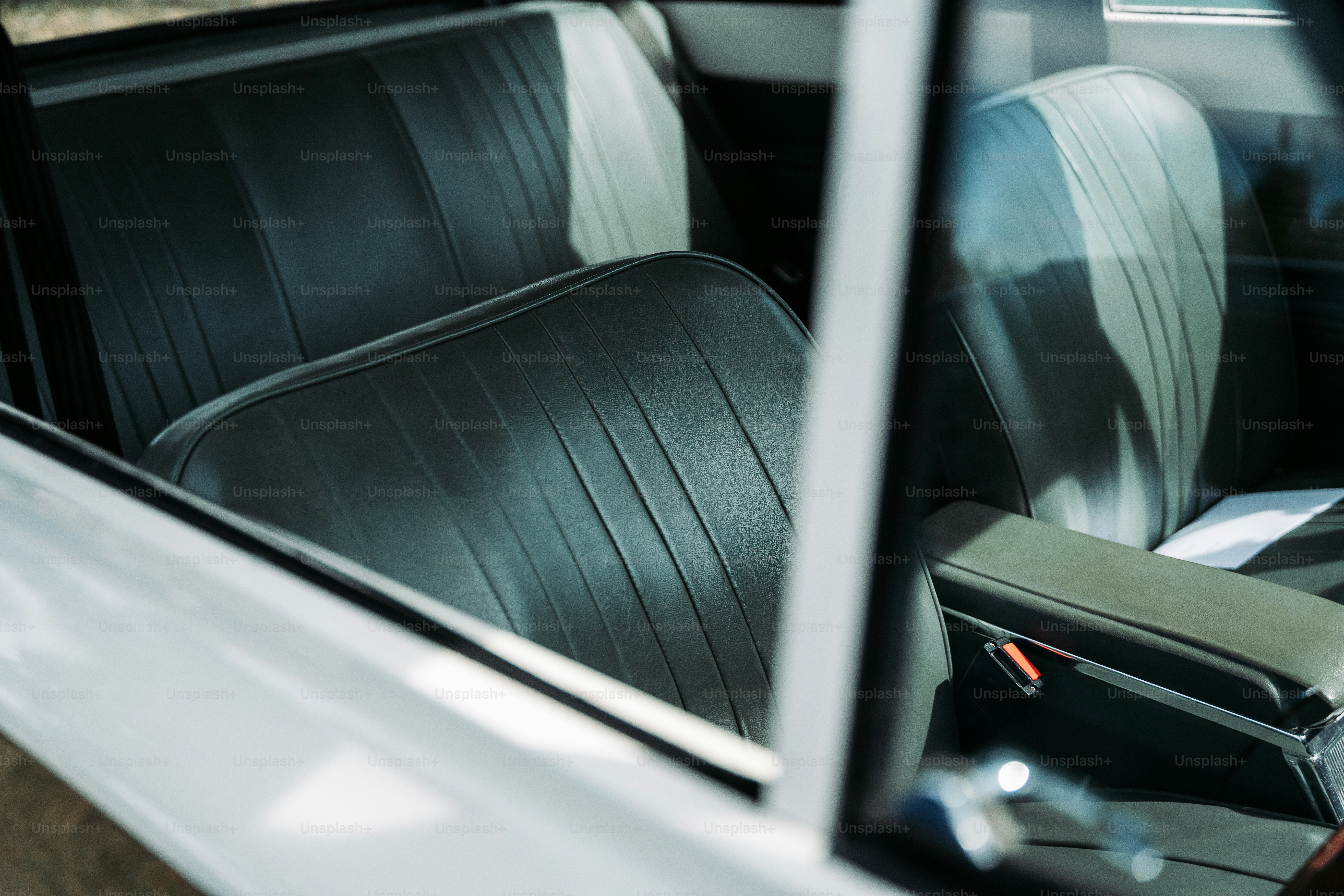 the interior of a car with black leather seats