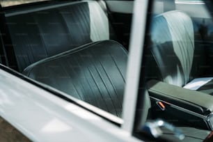 the interior of a car with black leather seats