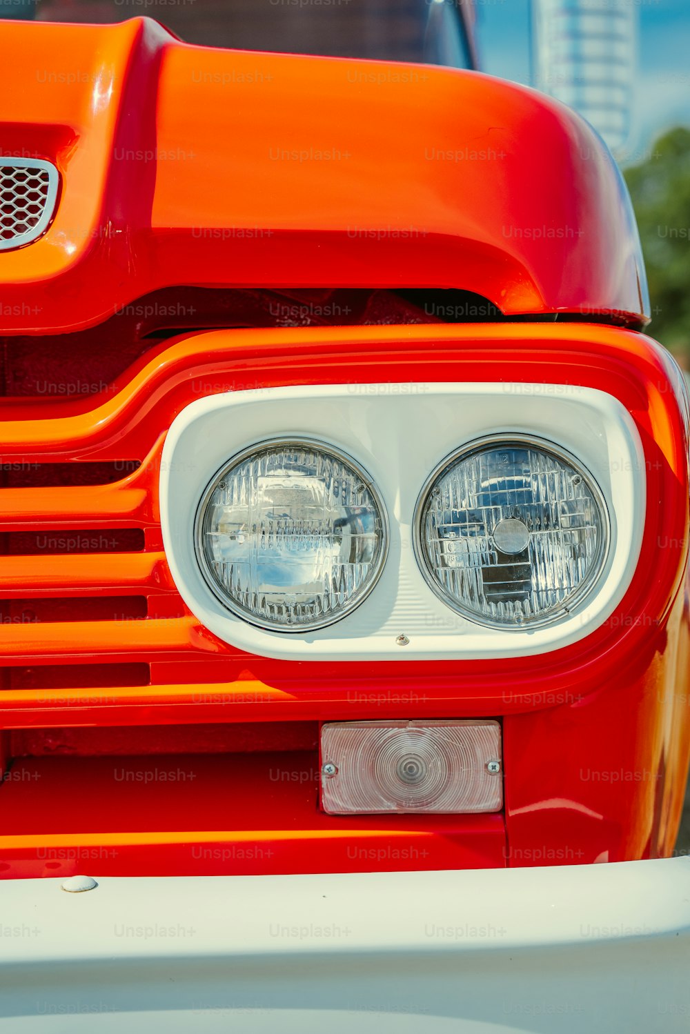 a close up of a bright orange truck headlight
