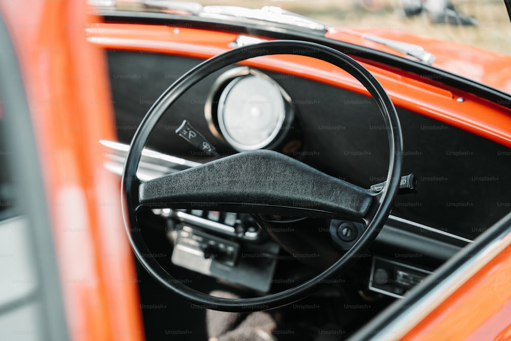 an orange car with a steering wheel and dashboard