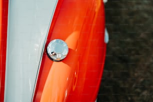 a close up of the front end of an orange and white motorcycle