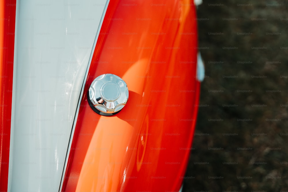 a close up of the front end of an orange and white motorcycle