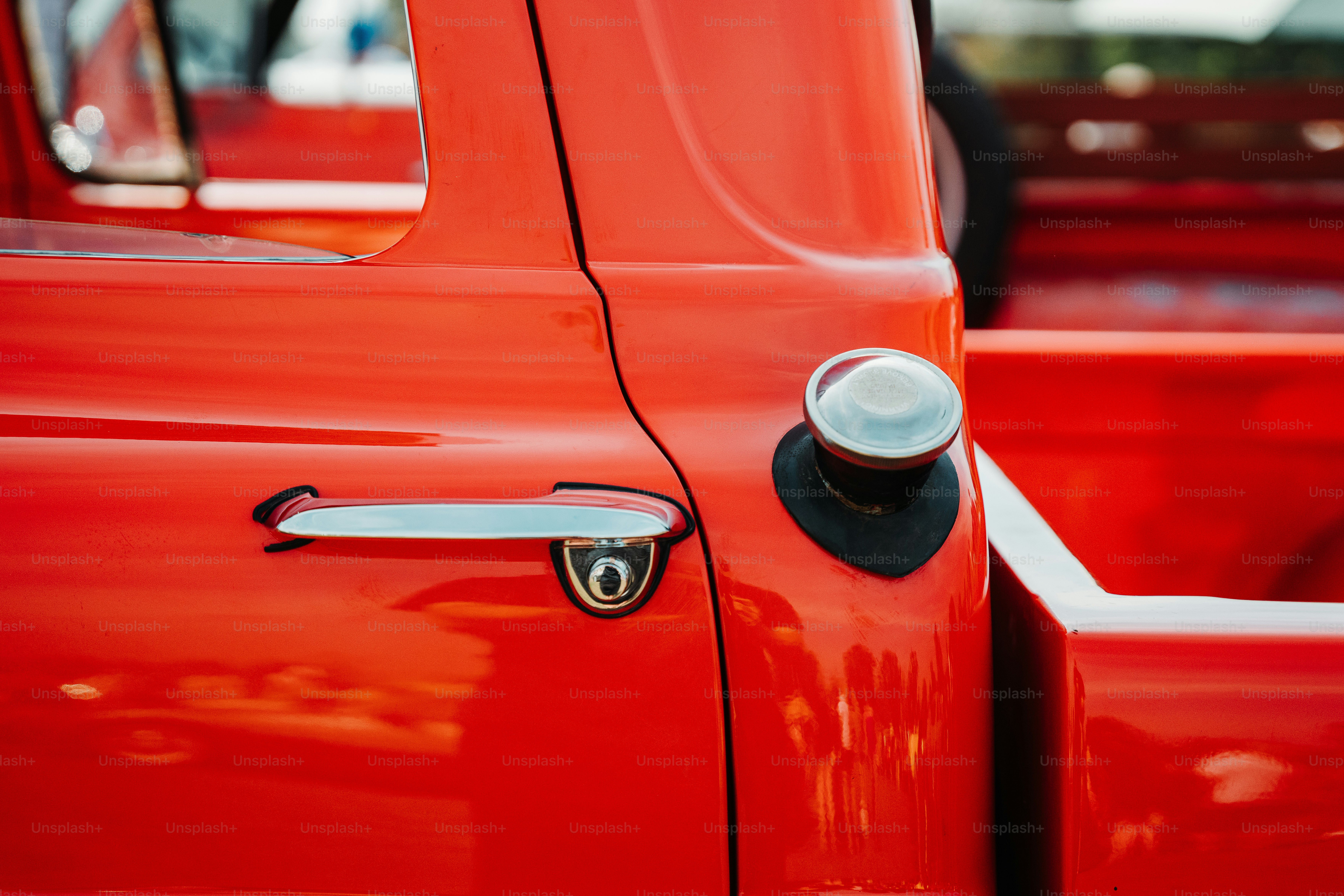 a close up of a red truck door handle