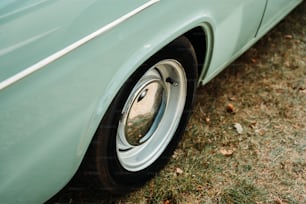 a close up of a car's wheel on the grass