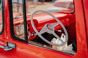 a red truck with a steering wheel and dashboard