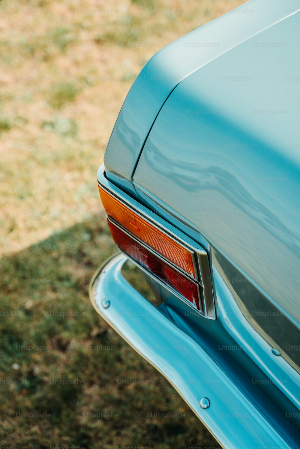 a close up of the tail end of a blue car