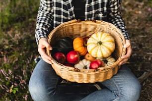 a woman holding a basket full of fruit