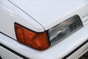 a close up of a white car's tail light