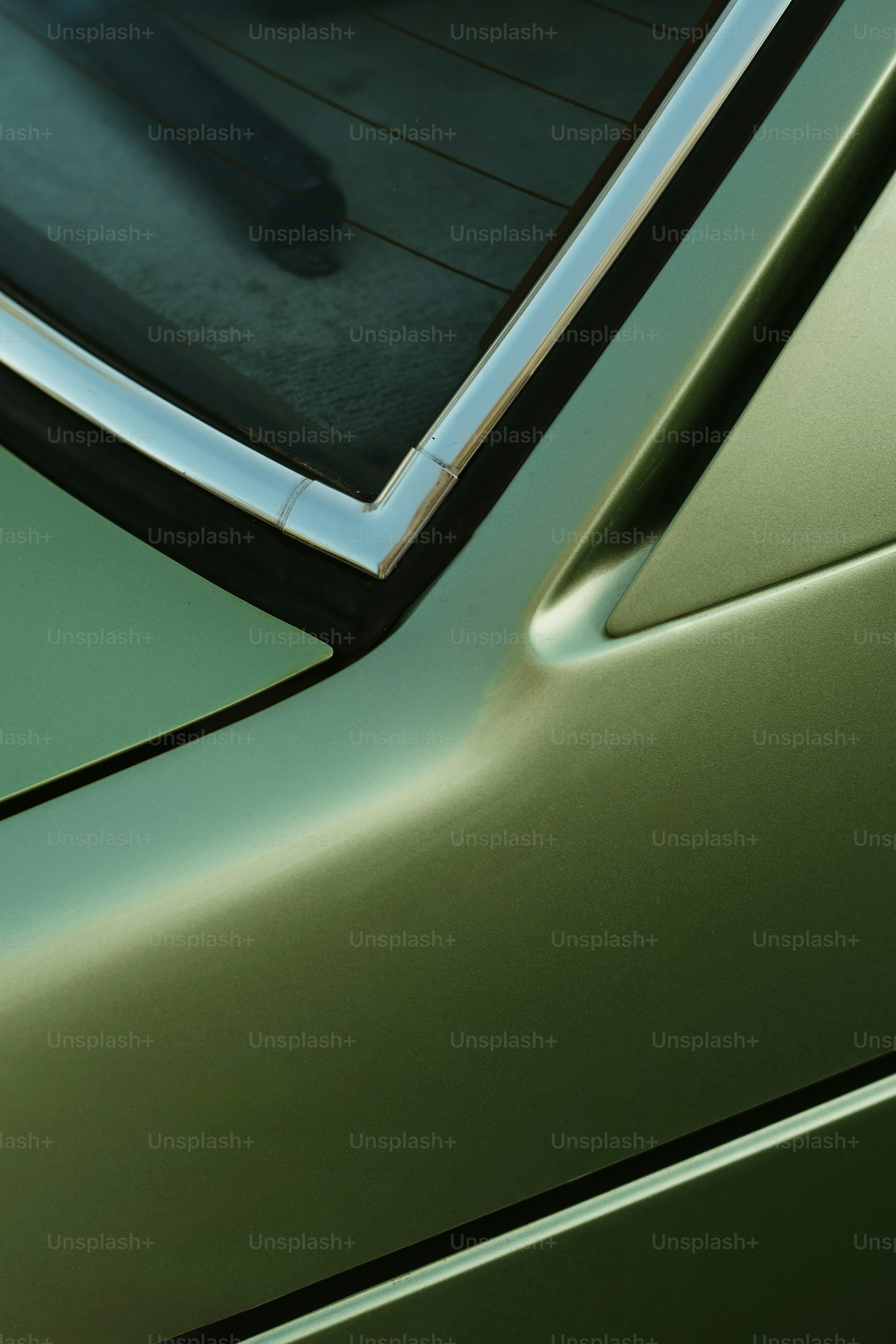 a close up of a car door with a person in the background