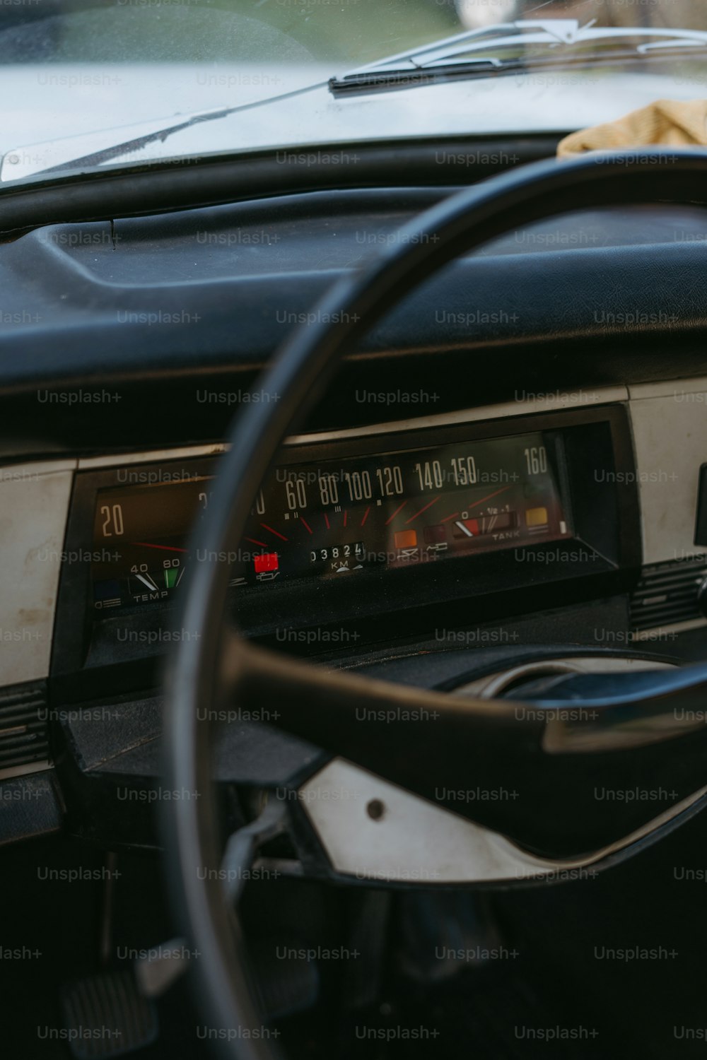 a car dashboard with a speedometer and a steering wheel