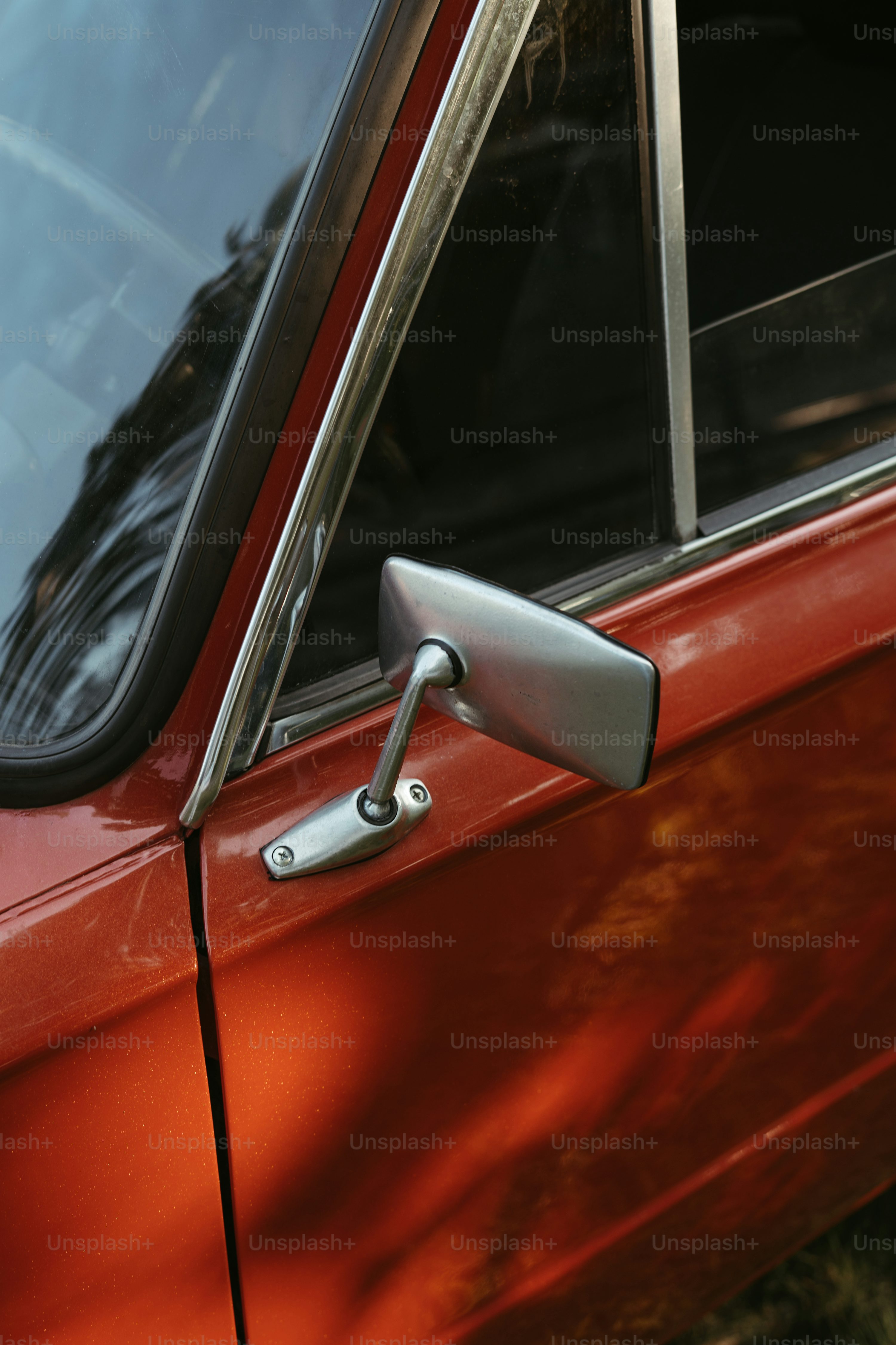 a close up of a red car door handle