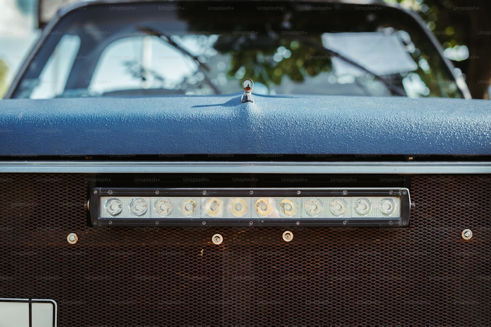 a close up of a radio with a car in the background