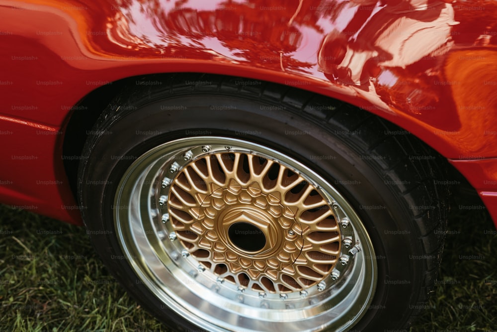 a close up of a wheel on a red car