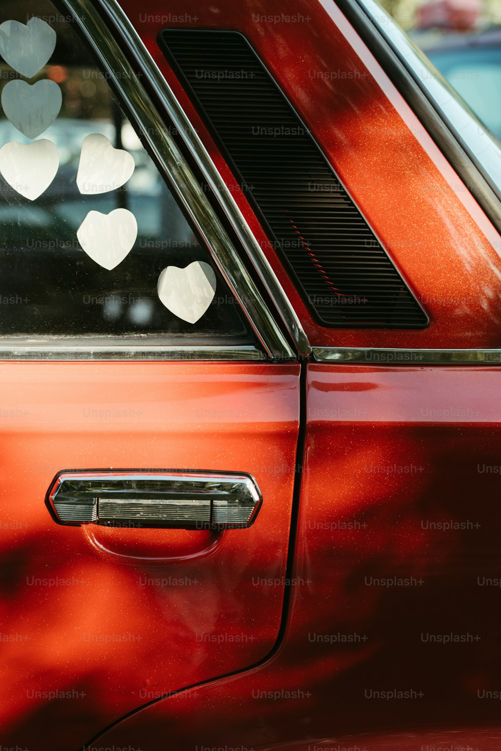 a red car with hearts on the window