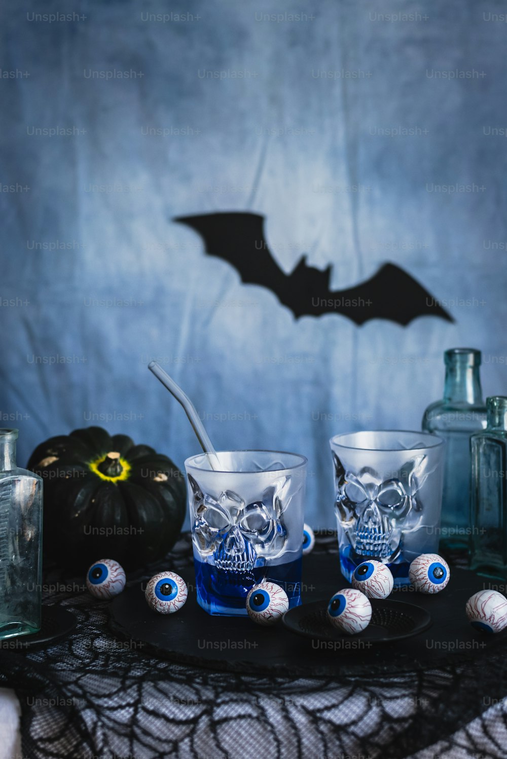 a table topped with glasses and bottles filled with liquid