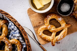 a table topped with pretzels next to a basket of cheese