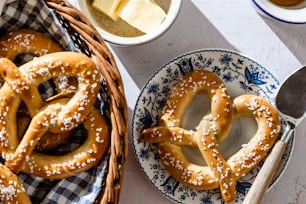 a basket of pretzels next to a basket of cheese