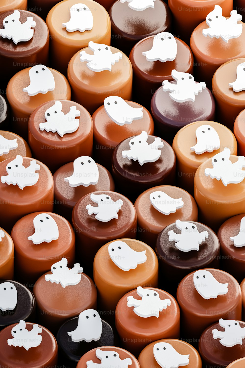 a pile of chocolates with white ghost decorations on them