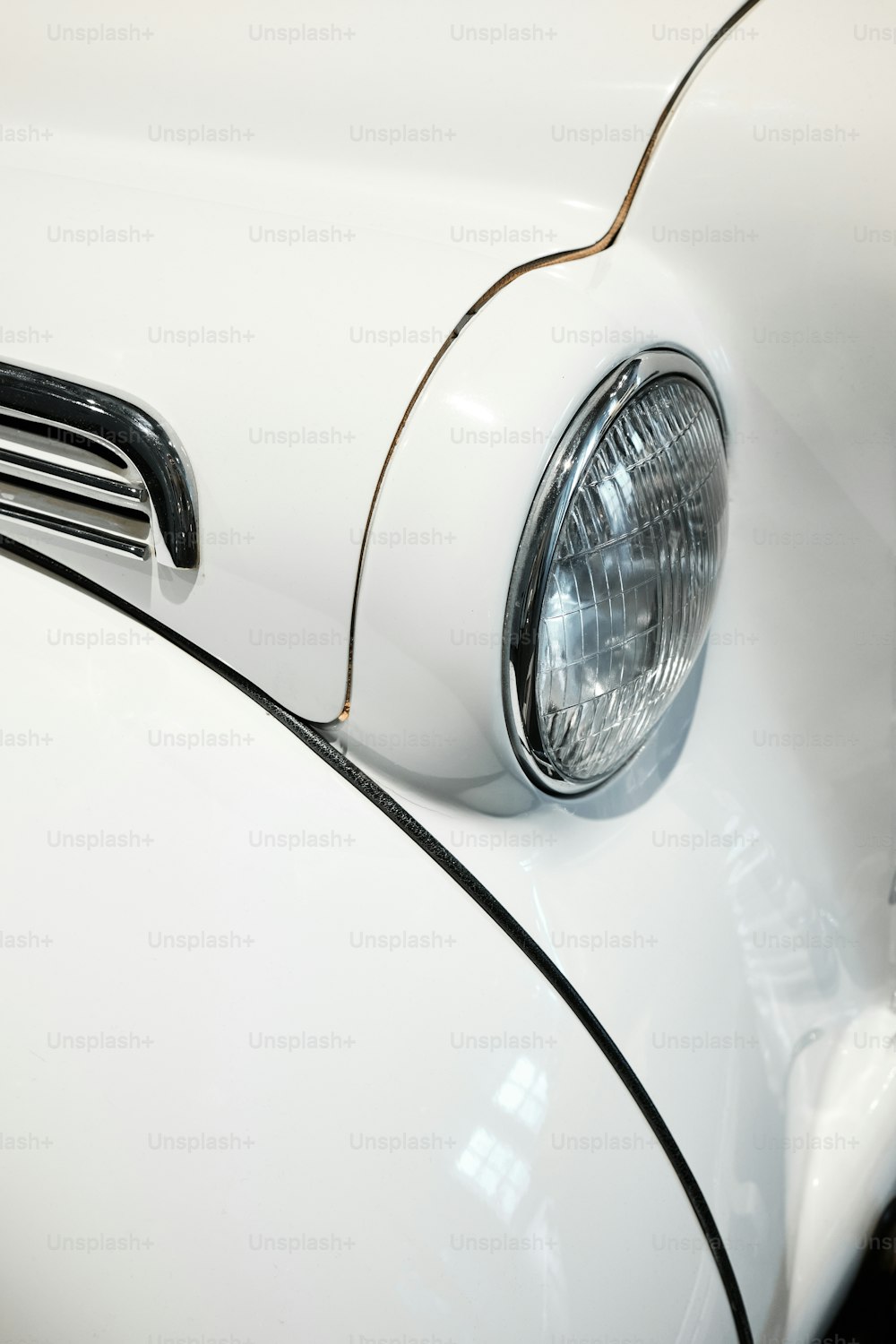 a close up of the front end of a white car