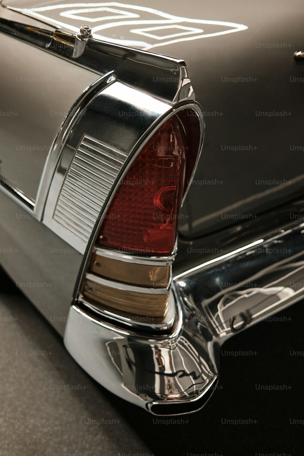 the back end of a classic car with chrome trim