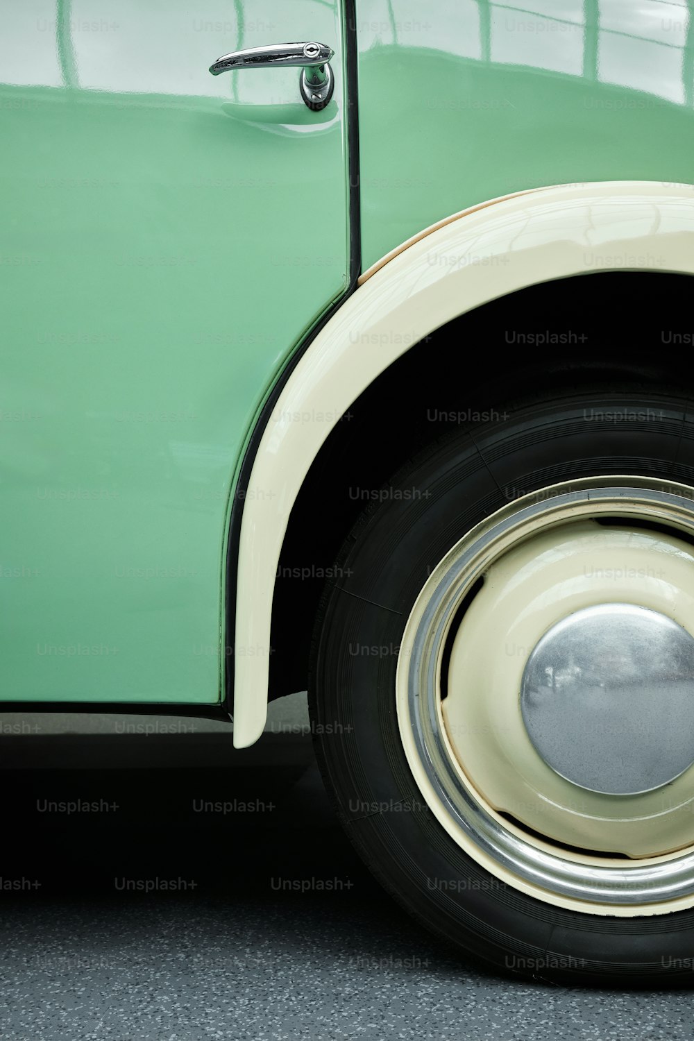a close up of a green and white truck tire
