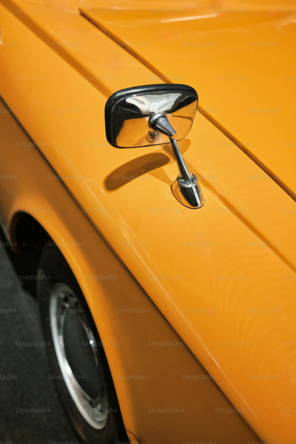 a close up of a yellow car door handle