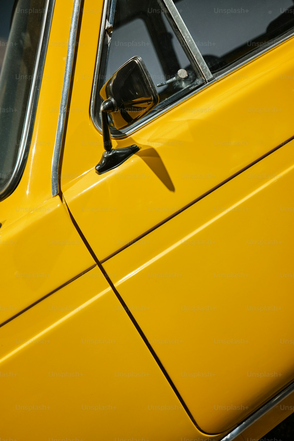 a close up of the side mirror of a yellow car