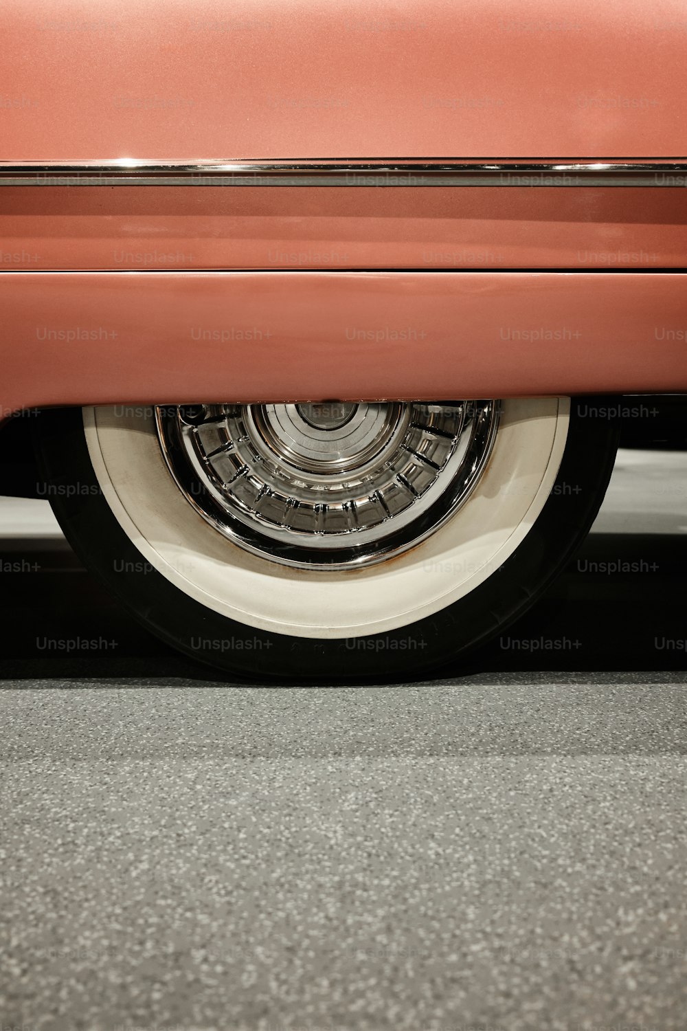 a close up of a red car's front tire