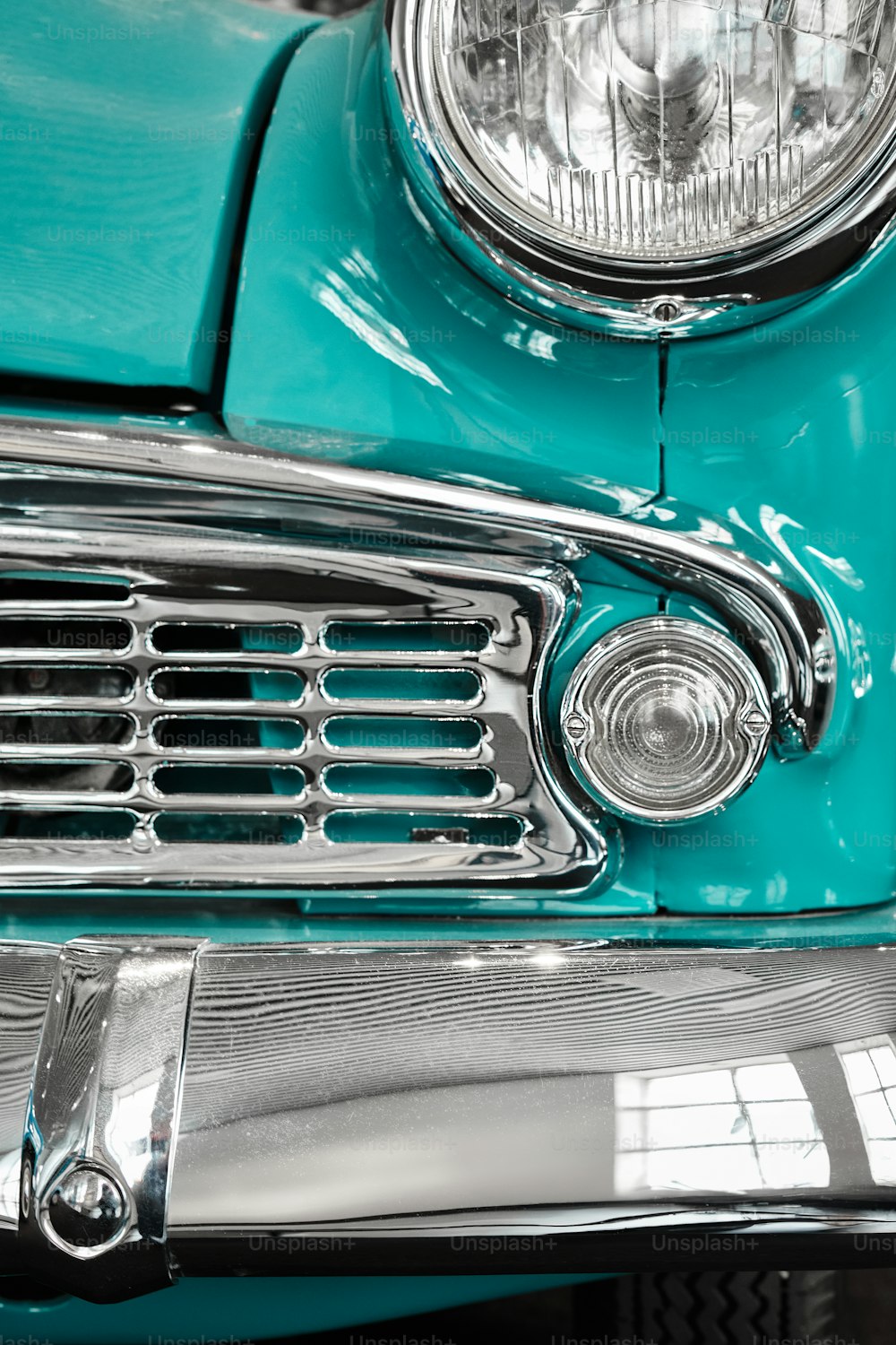 a close up of the front end of a classic car