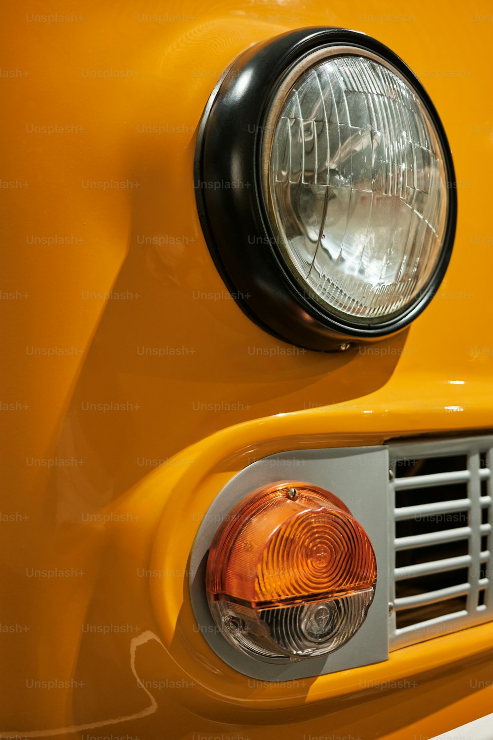 a close up of the front of a yellow truck