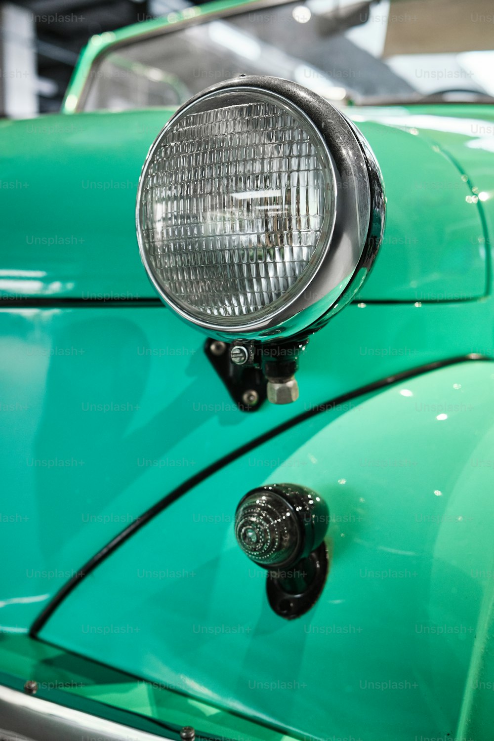 a close up of a green car with a light on