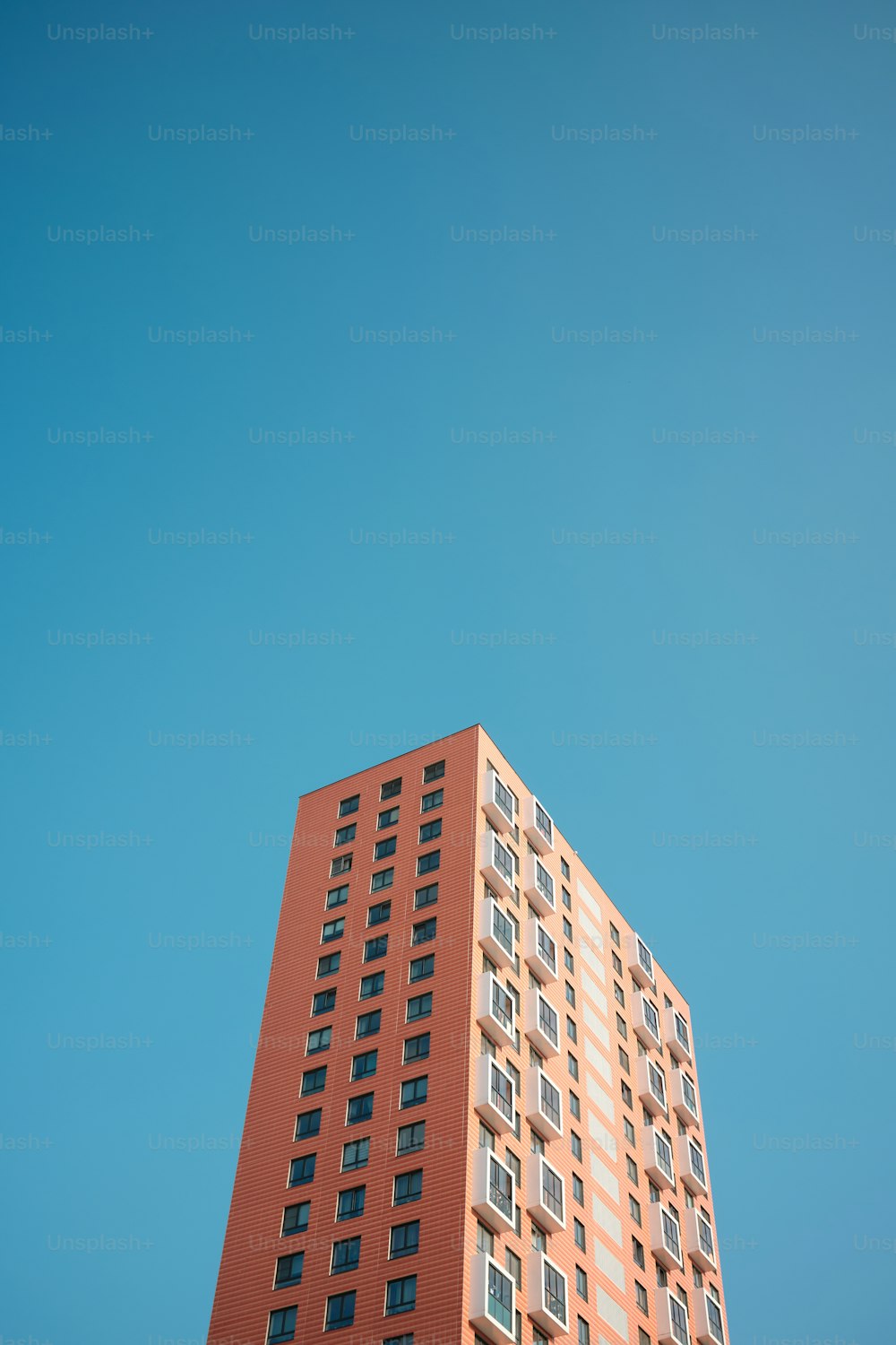 a tall red building with lots of windows