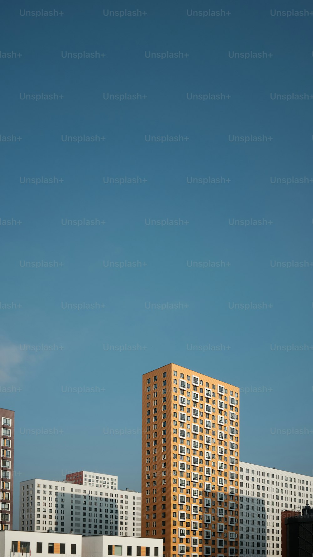 a plane flying over a city with tall buildings