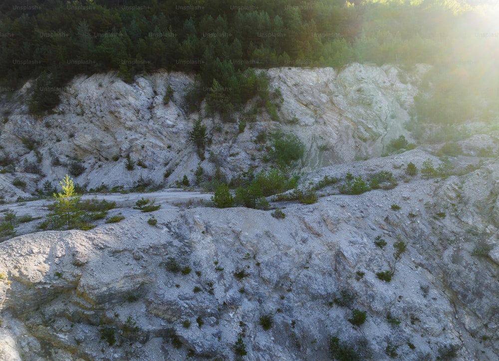 the sun shines brightly on the rocky terrain