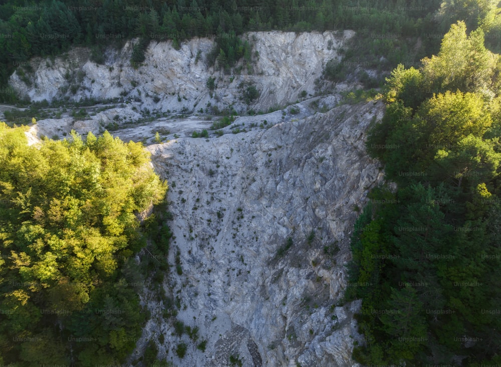 an aerial view of a rocky area with trees