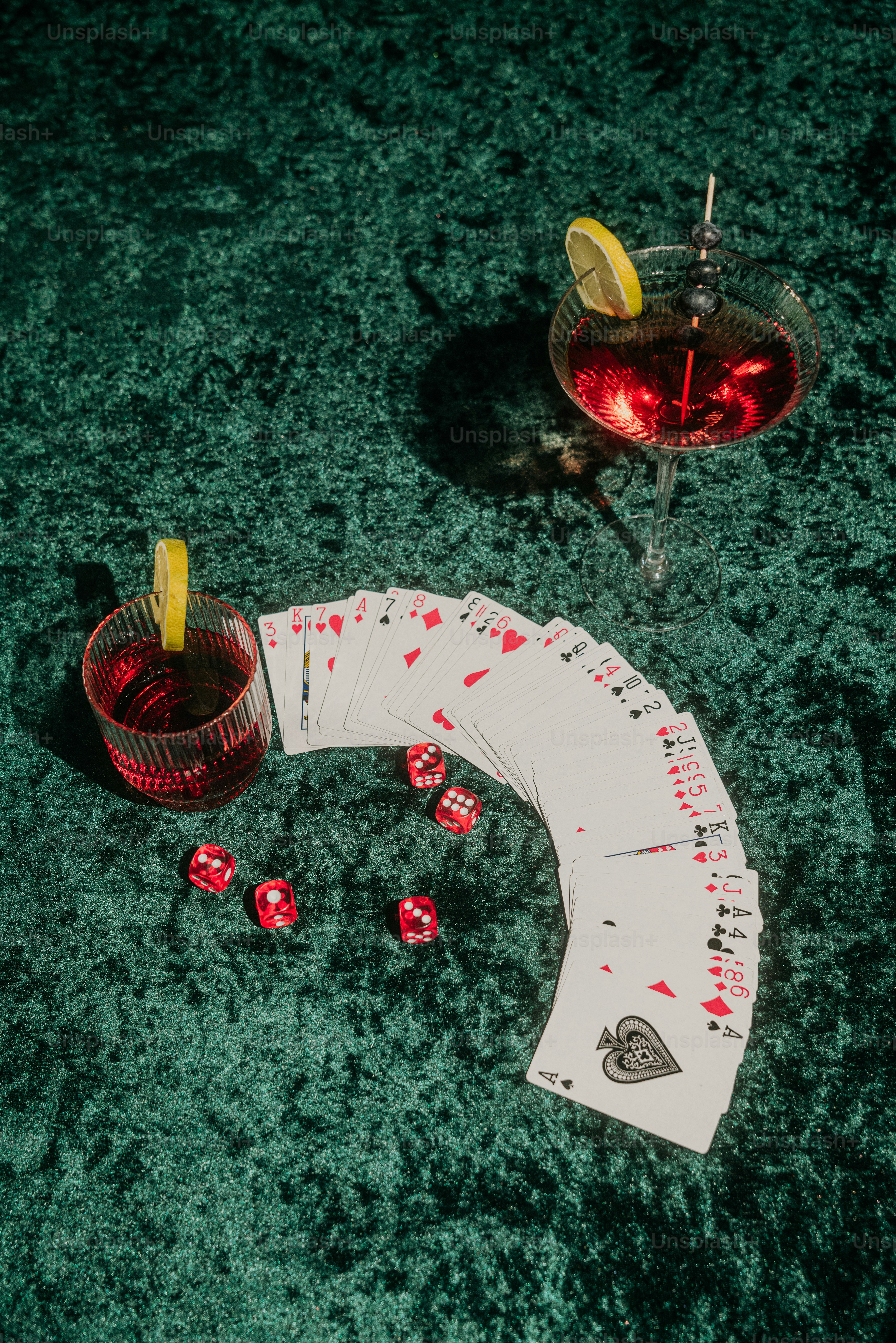 a table topped with cards and a drink