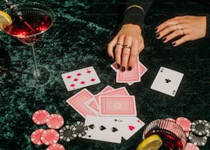 a table topped with cards and a glass of wine