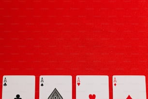 four of a kind of playing cards on a red background