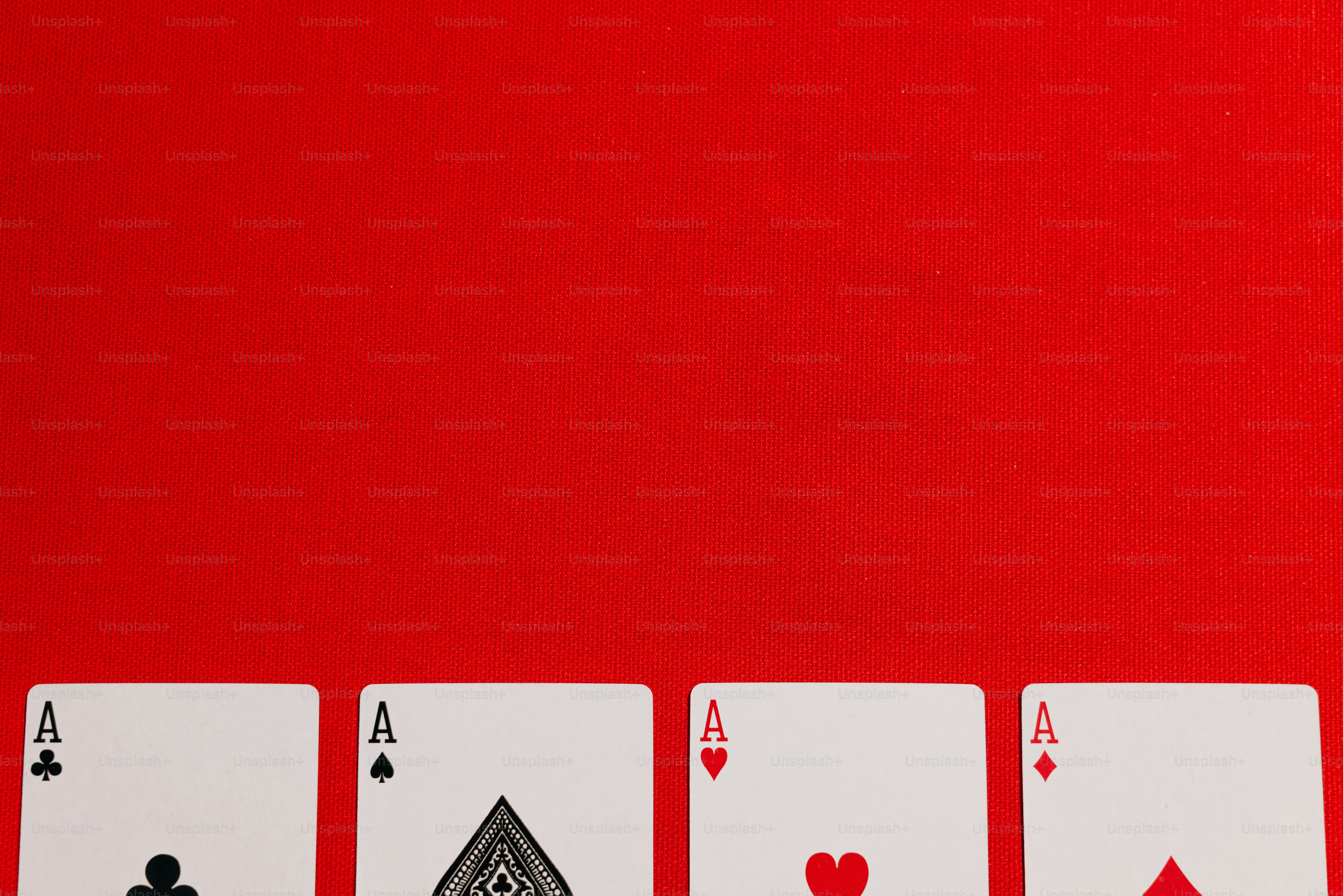 four of a kind of playing cards on a red background