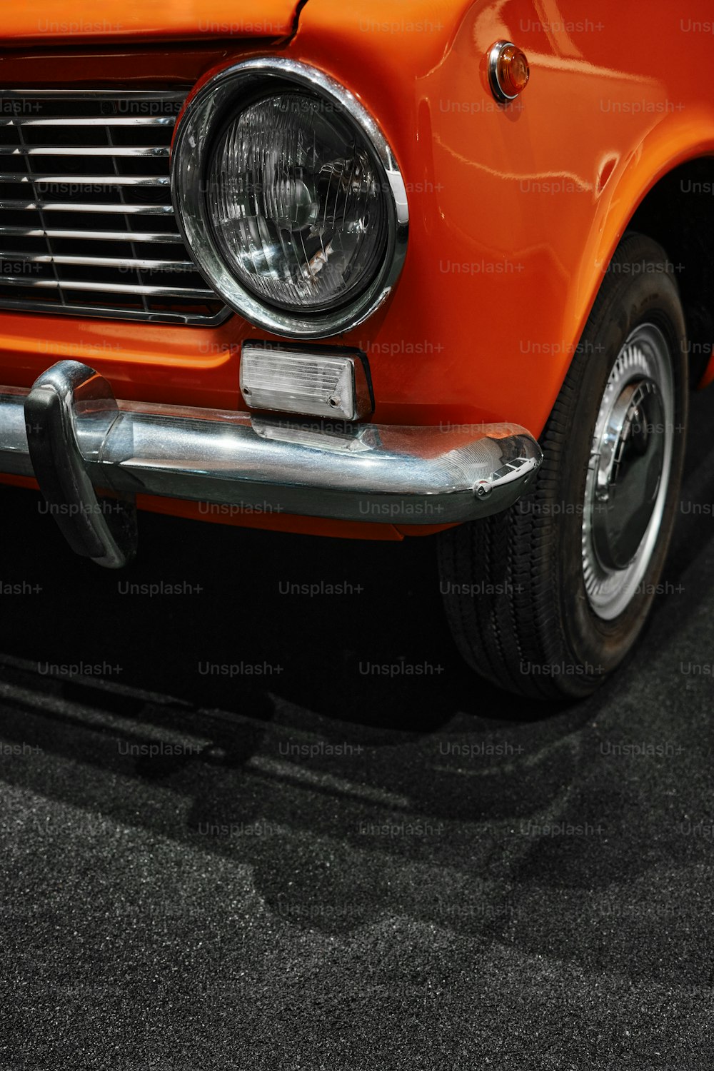 a close up of an orange classic car