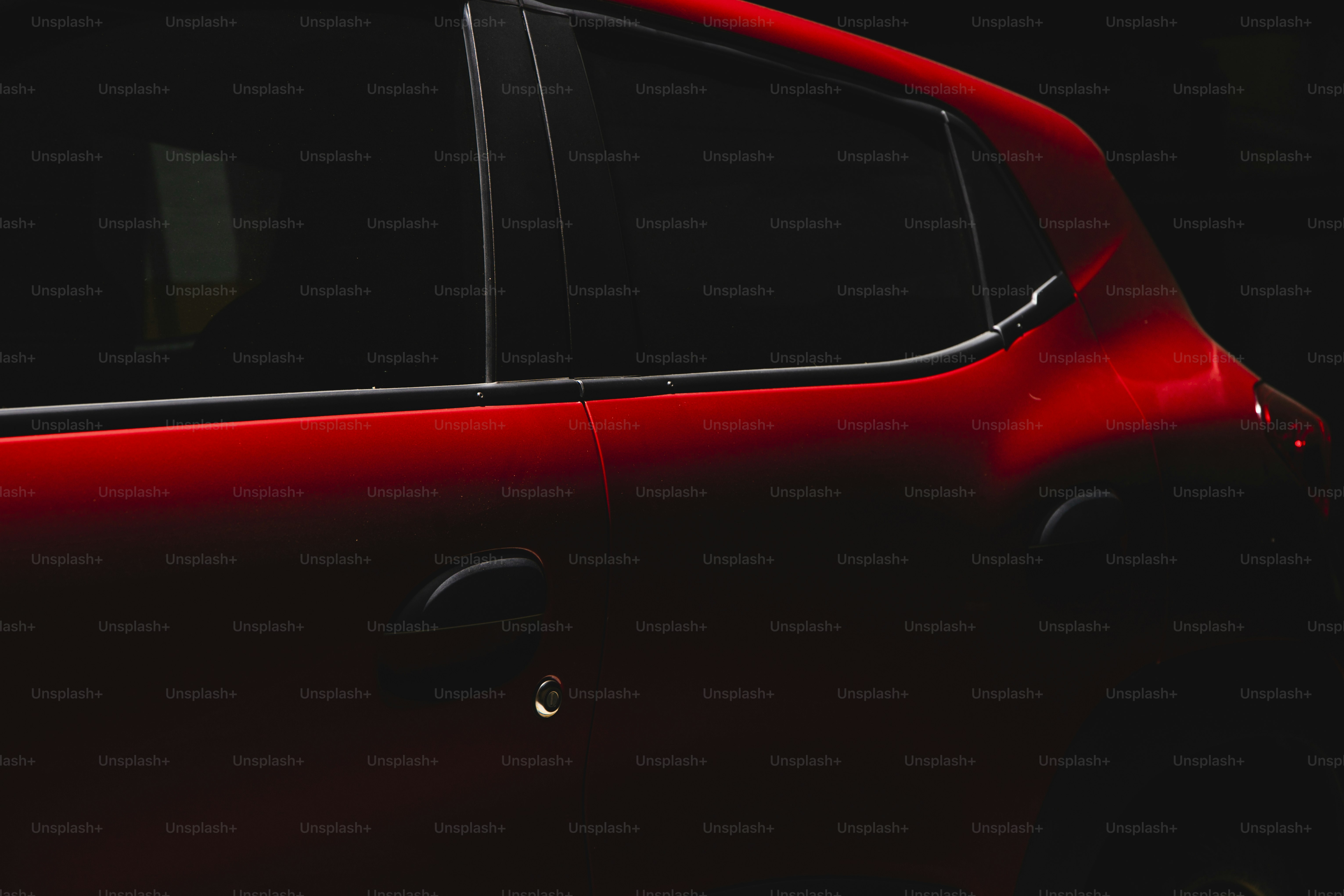 a close up of a red car in the dark
